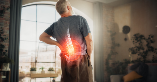 Man holding back in pain