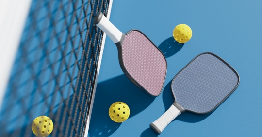 Pickleball equipment on a pickleball court in Florida.