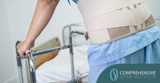 patient use walker in hospital to support walking due to back surgery