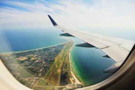 View of land and ocean from an airplane window