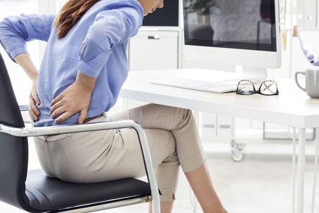 Office worker clutching lower back