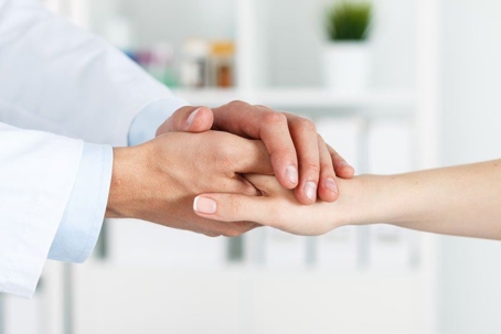 Provider holding patients hand