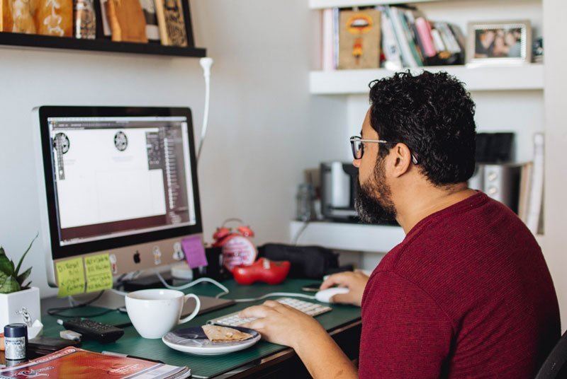 Man sitting with poor posture in front of a computer